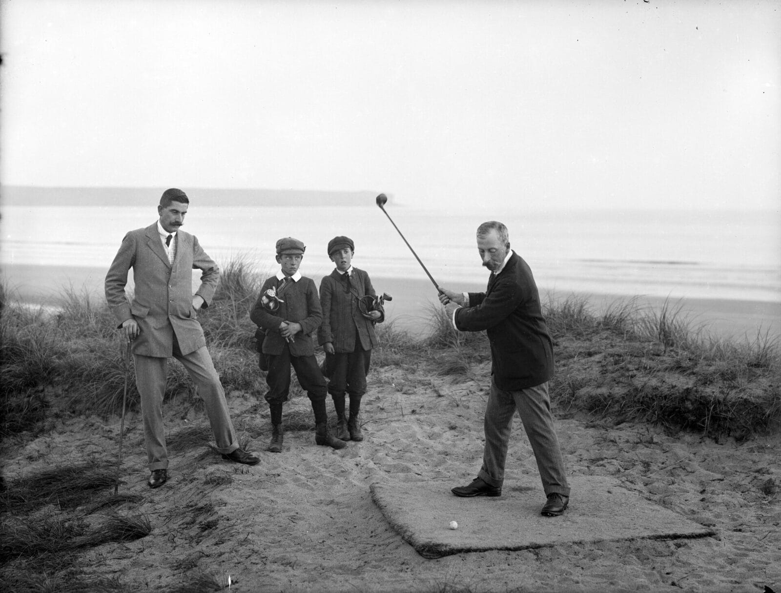 Golf caddies at Tramore, Ireland, around 1900